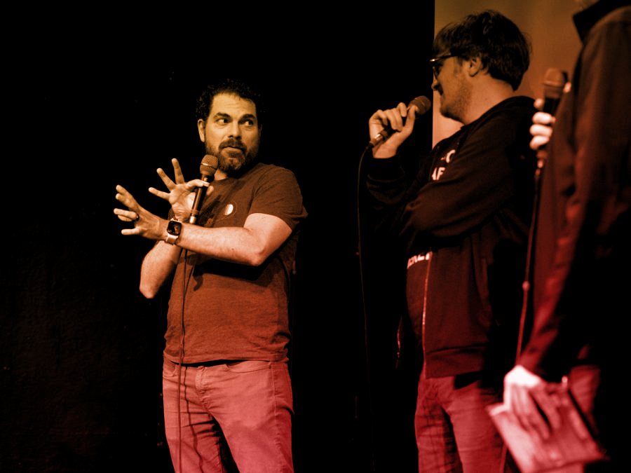 Dave Mercuri speaking with a microphone during a filmmaker Q&A