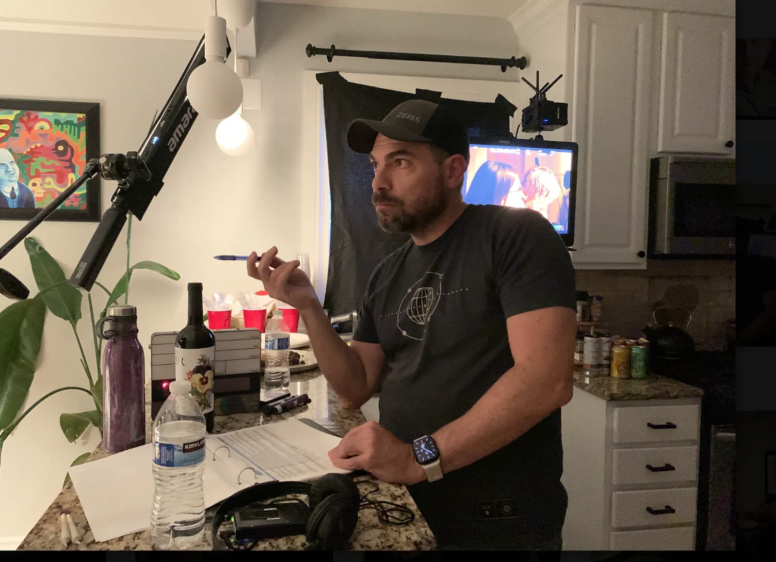 Director giving notes from behind the kitchen counter