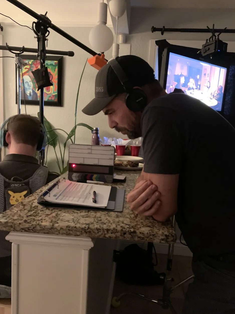Director at video village reviewing the shot list with headphones on